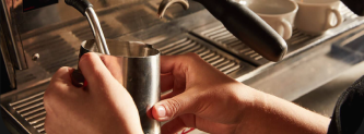 Close up of a barista steaming milk