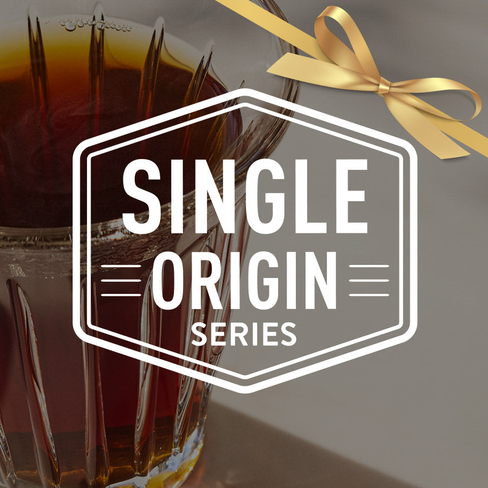 Glass of Coffee with a gold ribbon and 'Single Origin Series' label.